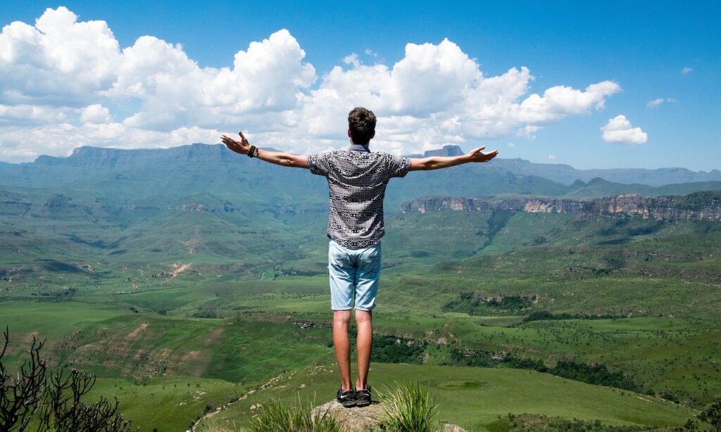 clouds, landscape, man, mountain range, mountains, nature, person, sky, standing, man, standing, standing, standing, standing, standing